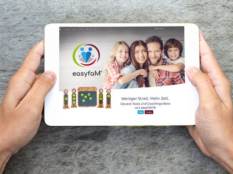 Male hands holding a tablet with easyfaM website and easyfaM Taskboard
